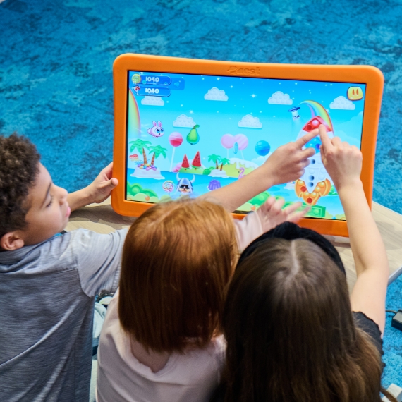 A young girl panting alongside a Whazoodle device
