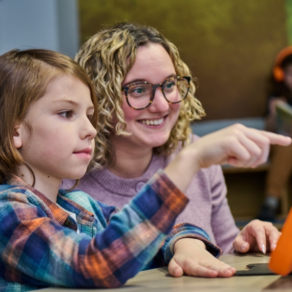 A mother and daughter enjoying a Whazoodle speaker together