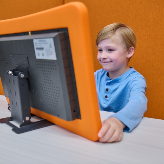 Two boys playing games with their Whazoodle speaker