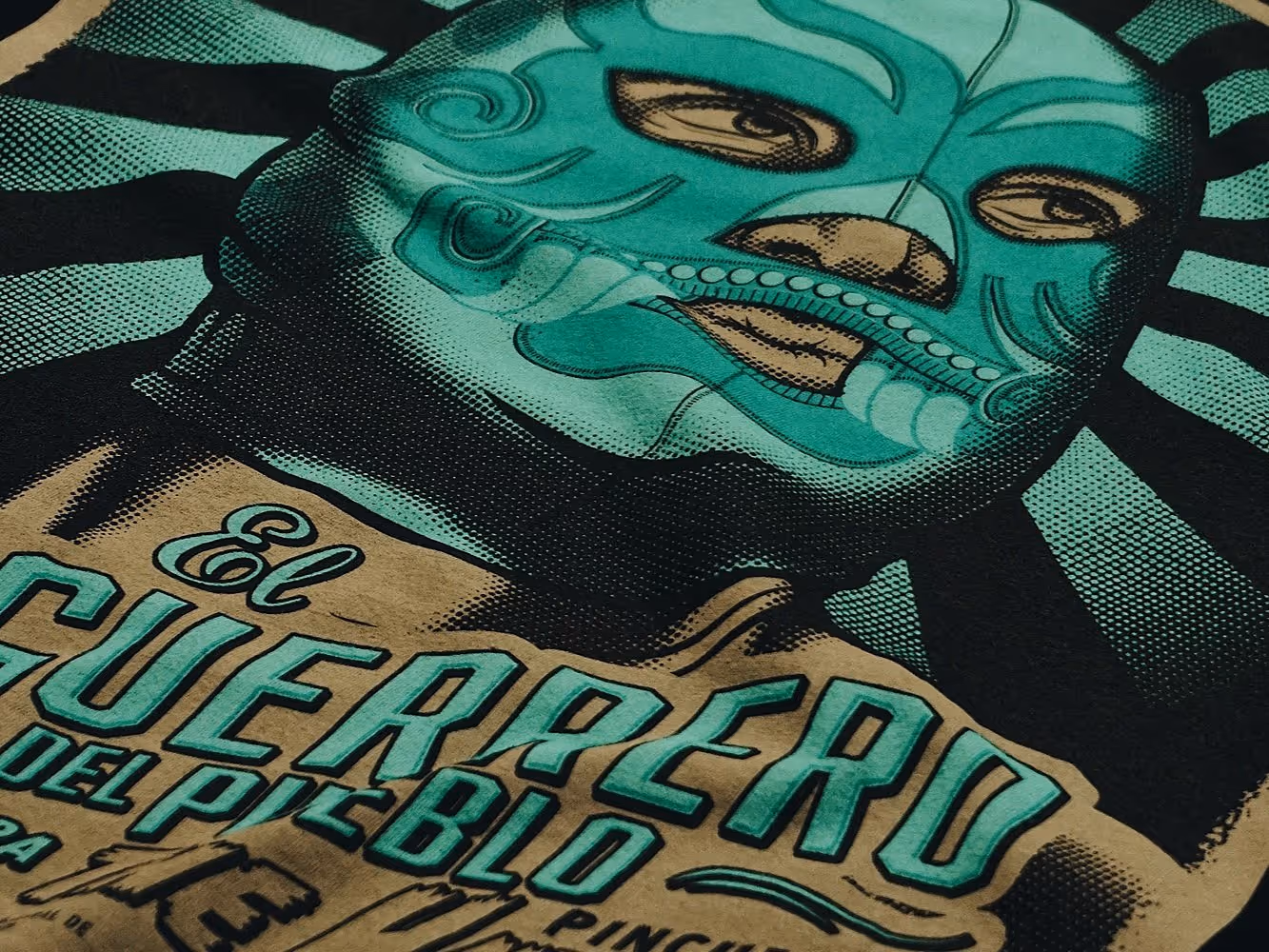 A close-up of a Maldición ™water based discharge print design on a black tee