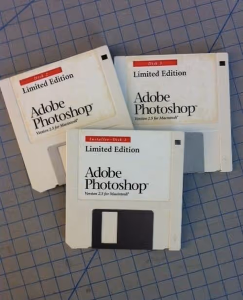 Three vintage floppy disks with Adobe Photoshop Version 2.5 Limited Edition for Macintosh