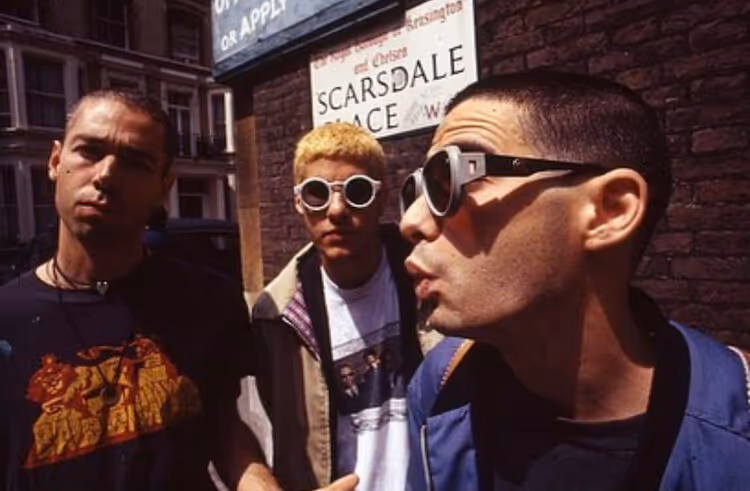 Three young men on urban street with Scarsdale Place sign
