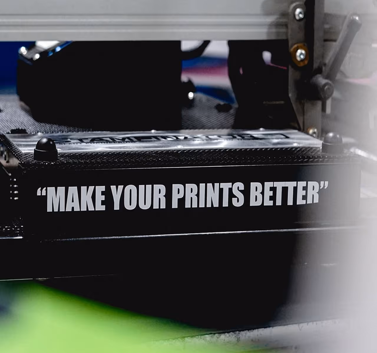 A "Make Your Prints Better" decal placed on a printing press machine
