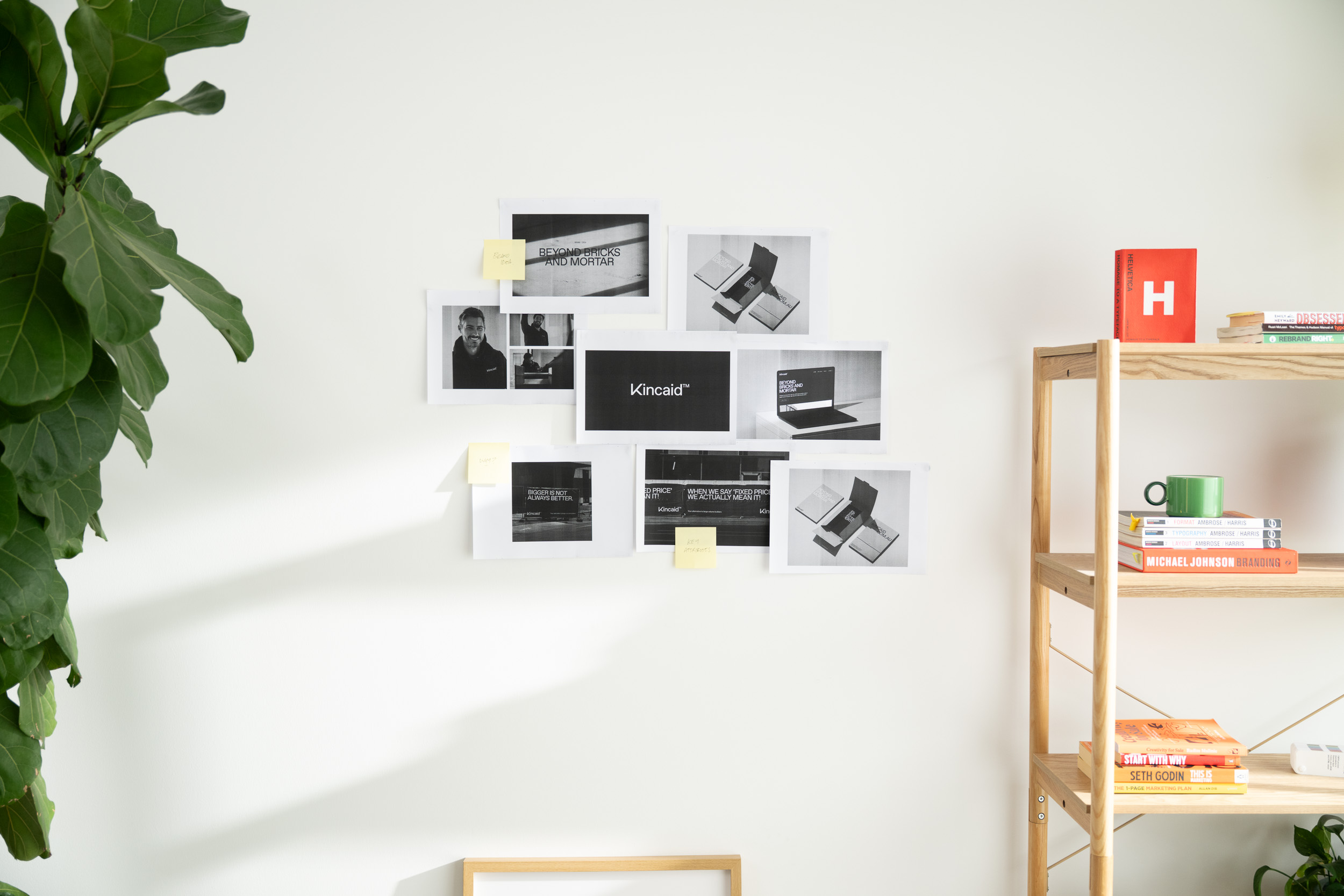 Shot of the studio with work pinned to the wall and a bookshelf