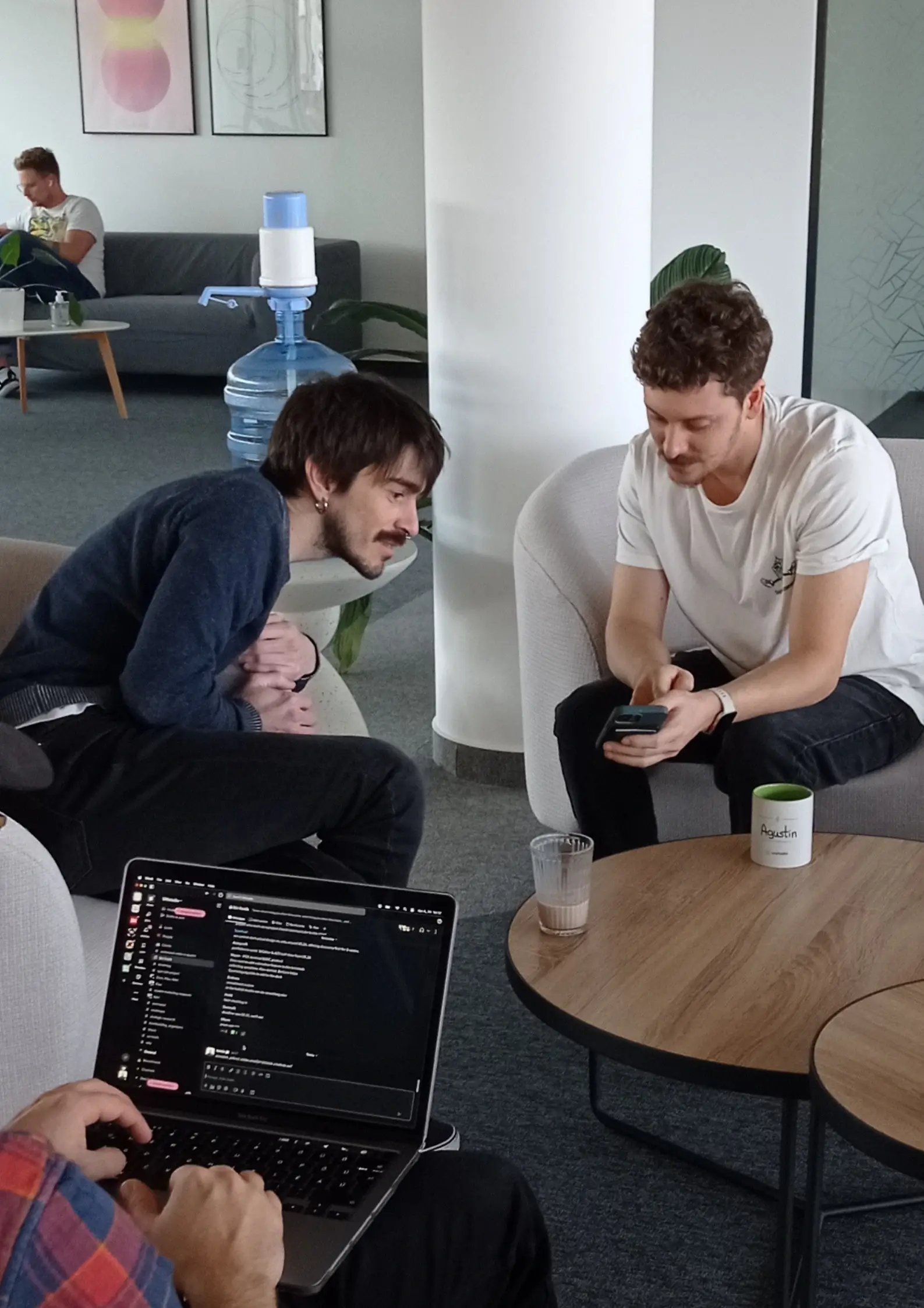 Two designers checking out a mobile app at UX studio's office