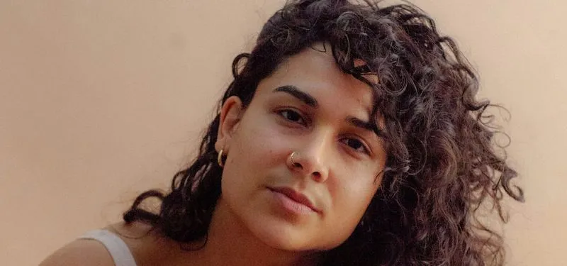 a close up of a person with curly hair