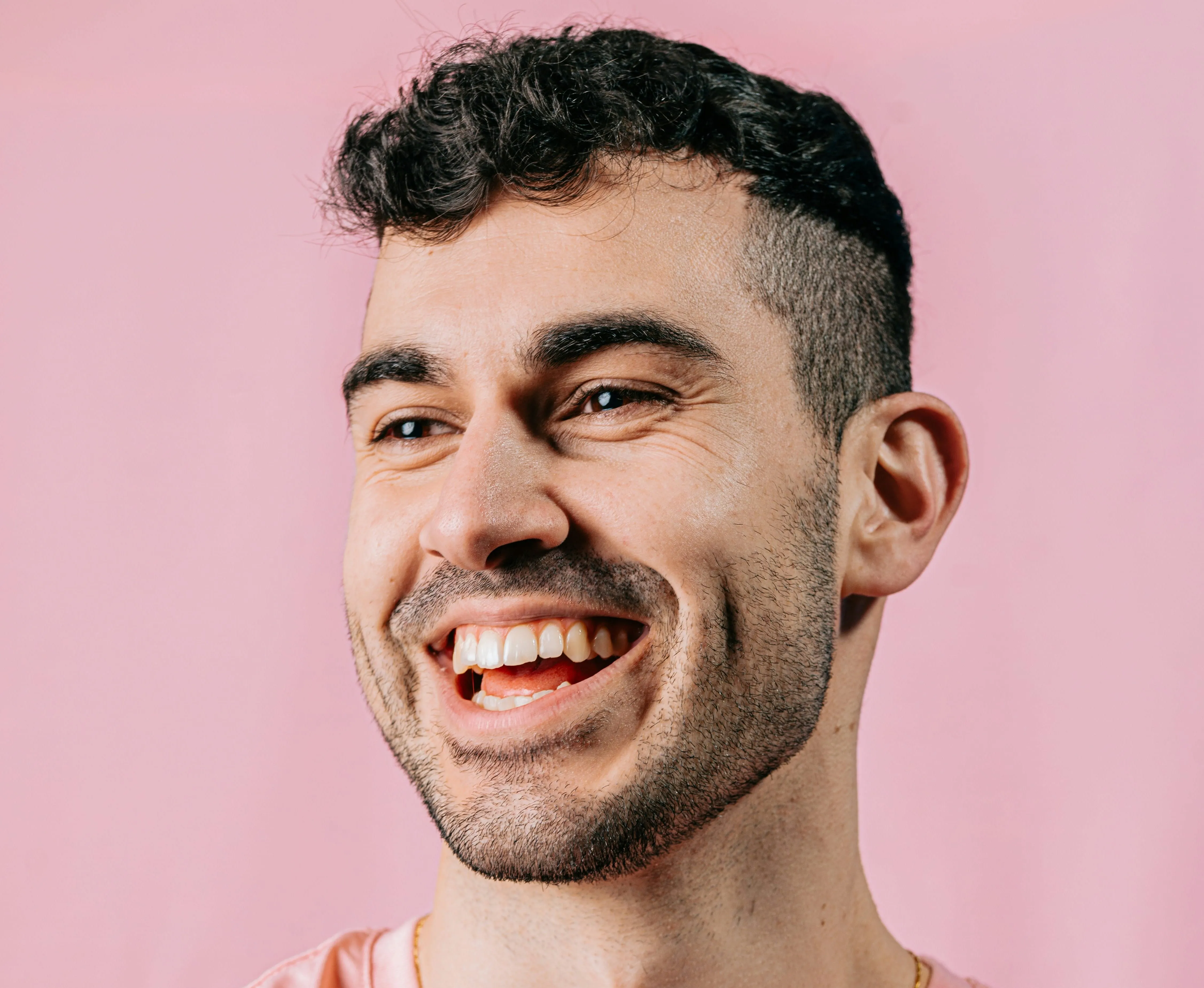 a man with a beard smiling at the camera