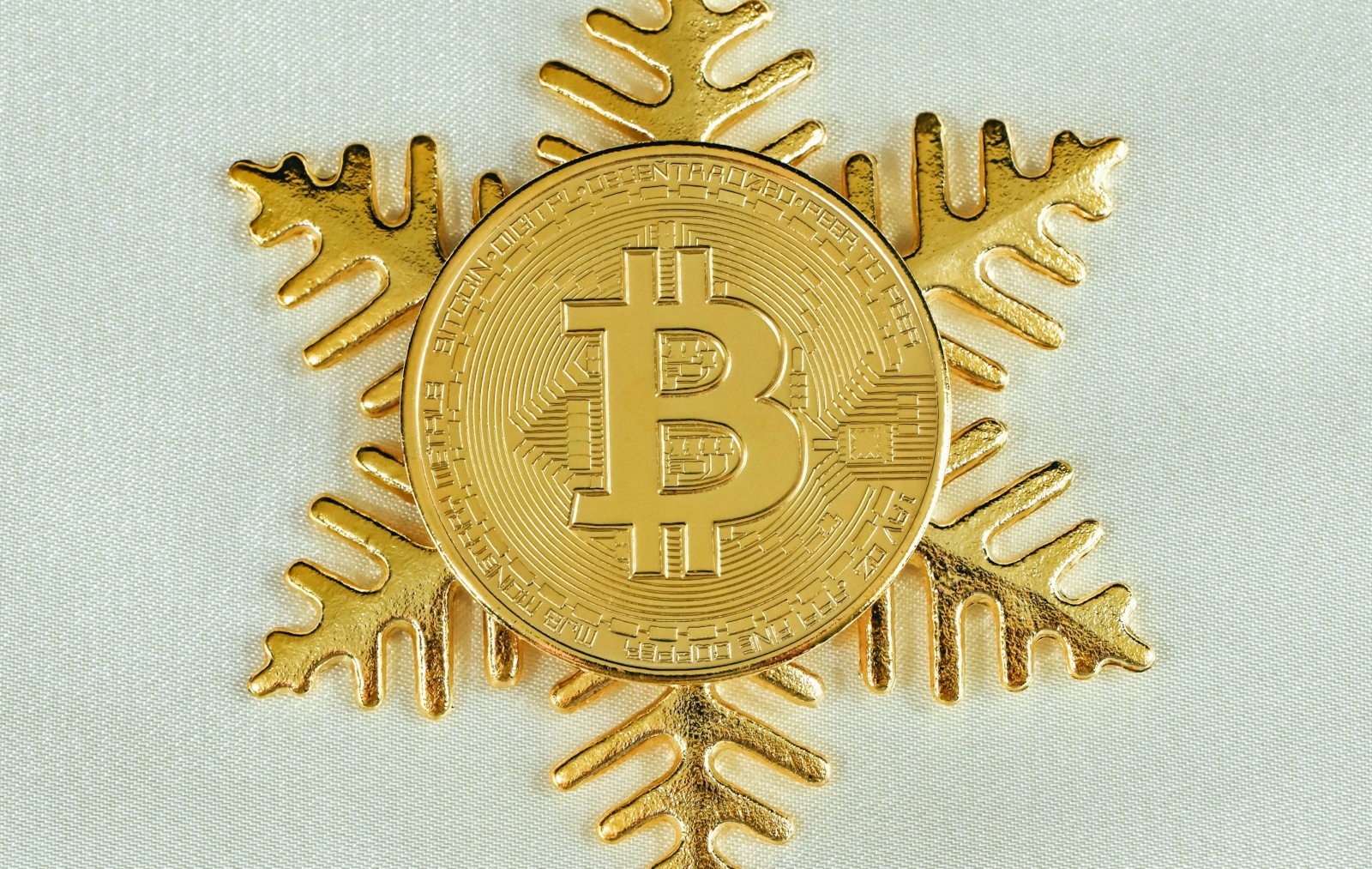 A gold coin with a snowflake design on it.