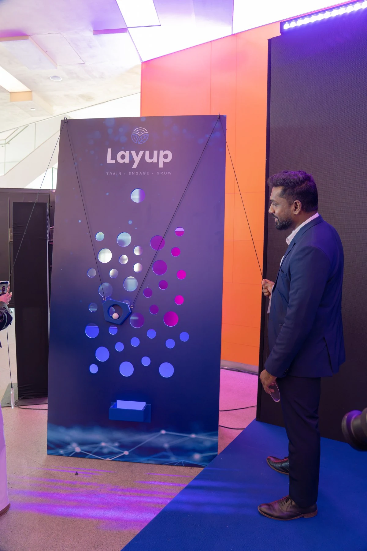 Attendees at the Layup collaborative ball activity wall