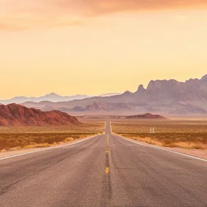 Desert highway background image with mountains and open road