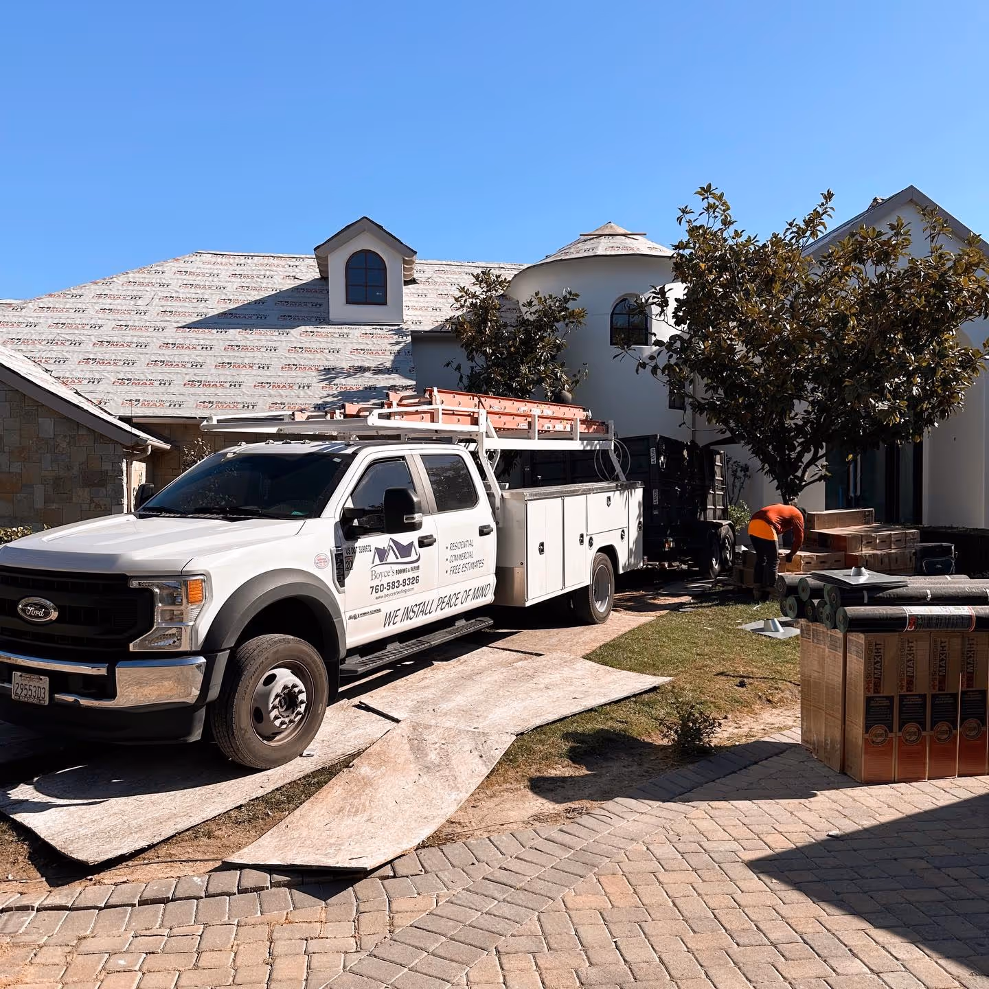 Boyce’s Roofing truck at residential roof replacement job site