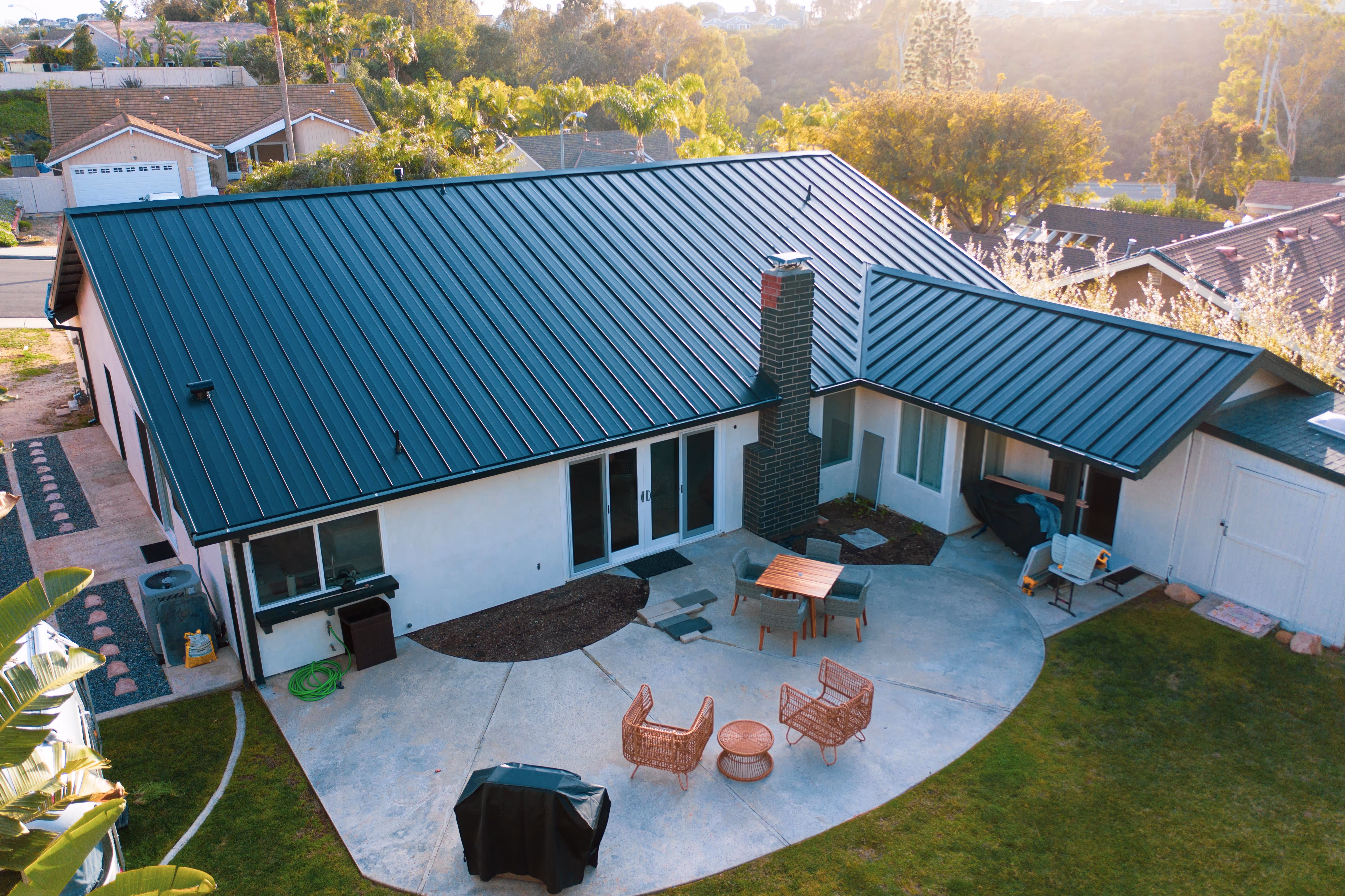 Modern home with a dark green standing seam metal roof