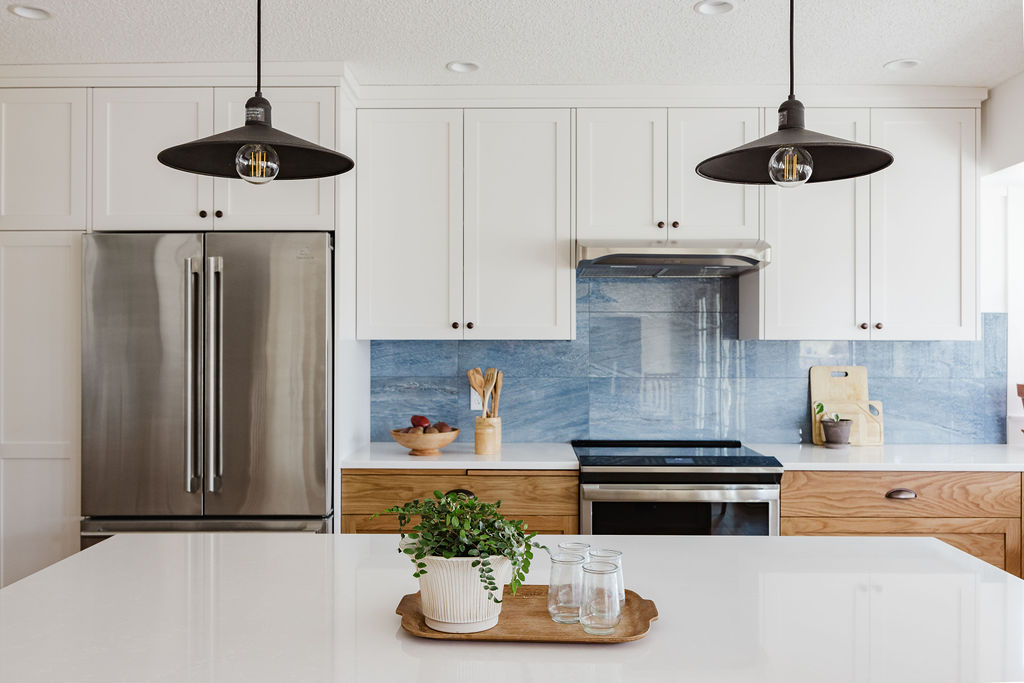 full kitchen remodel with new white upper cabinets, white oak lower cabinets and quartz countertops