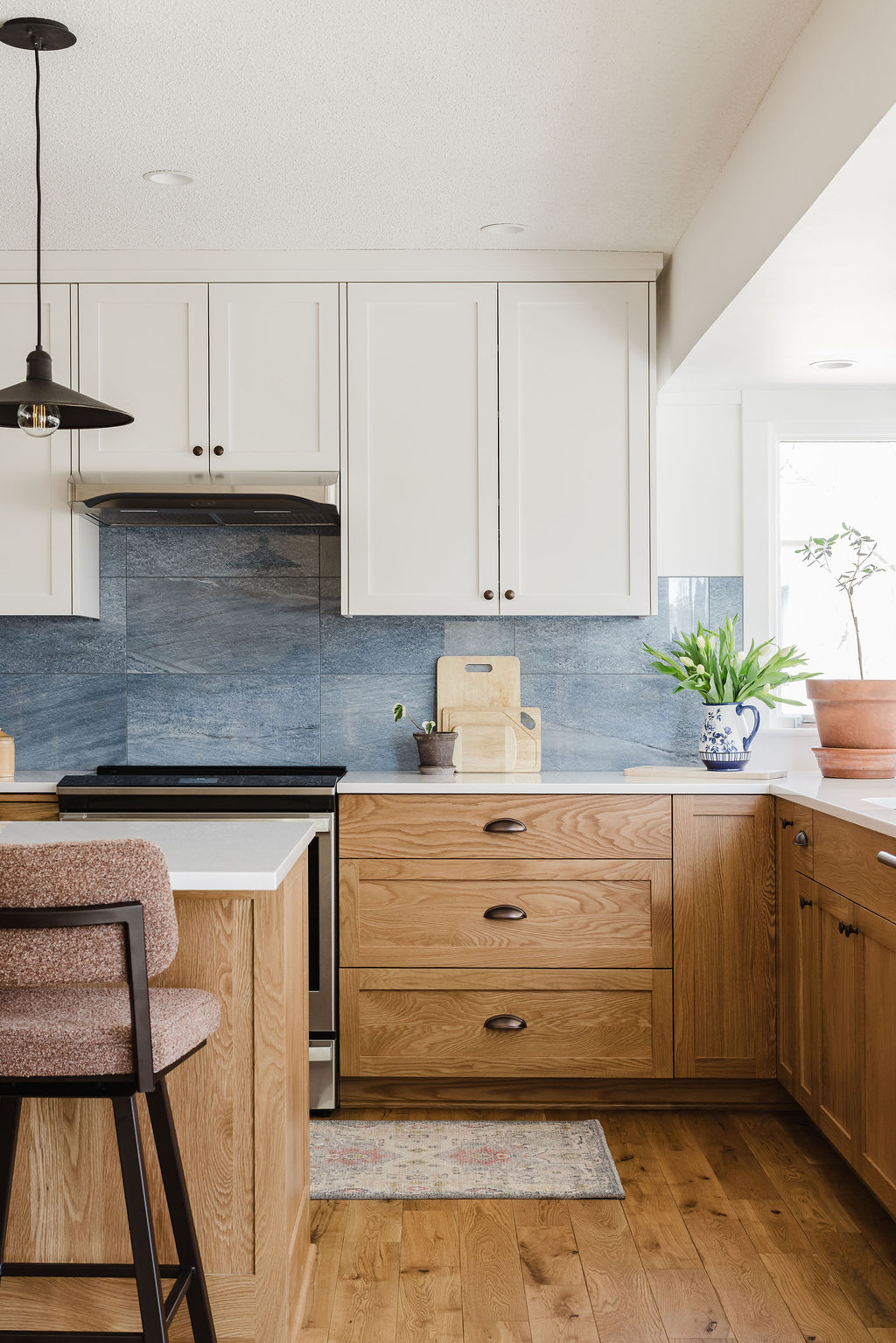 kitchen remodel with new custom white oak cabinets, white oak hardwood floors, and new appliances.