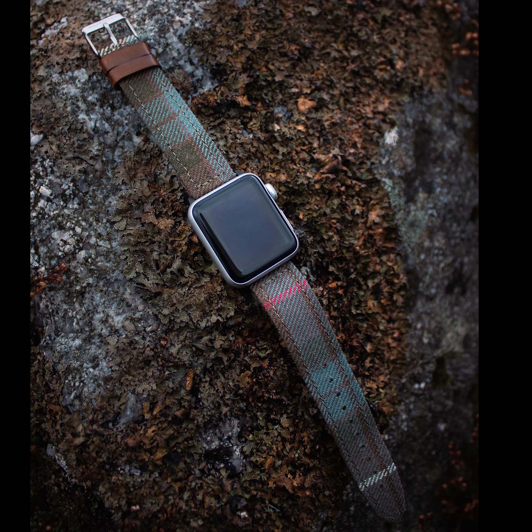 An Apple Watch on a rock with personalised MacKinnon strap 