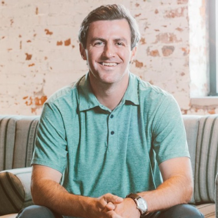 A photo of a man smiling.