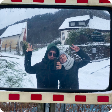 My man and I waving at the camera through the traffic mirror on the street 