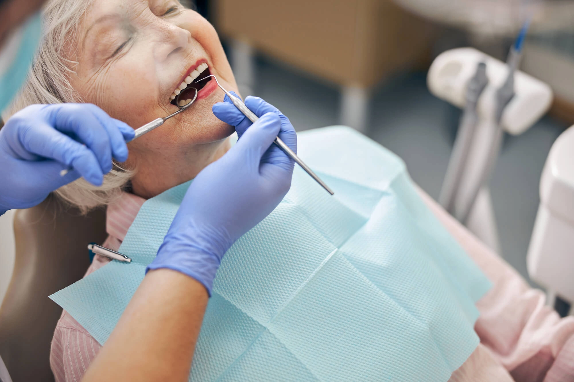 Woman putting fixed dentures steele creek nc