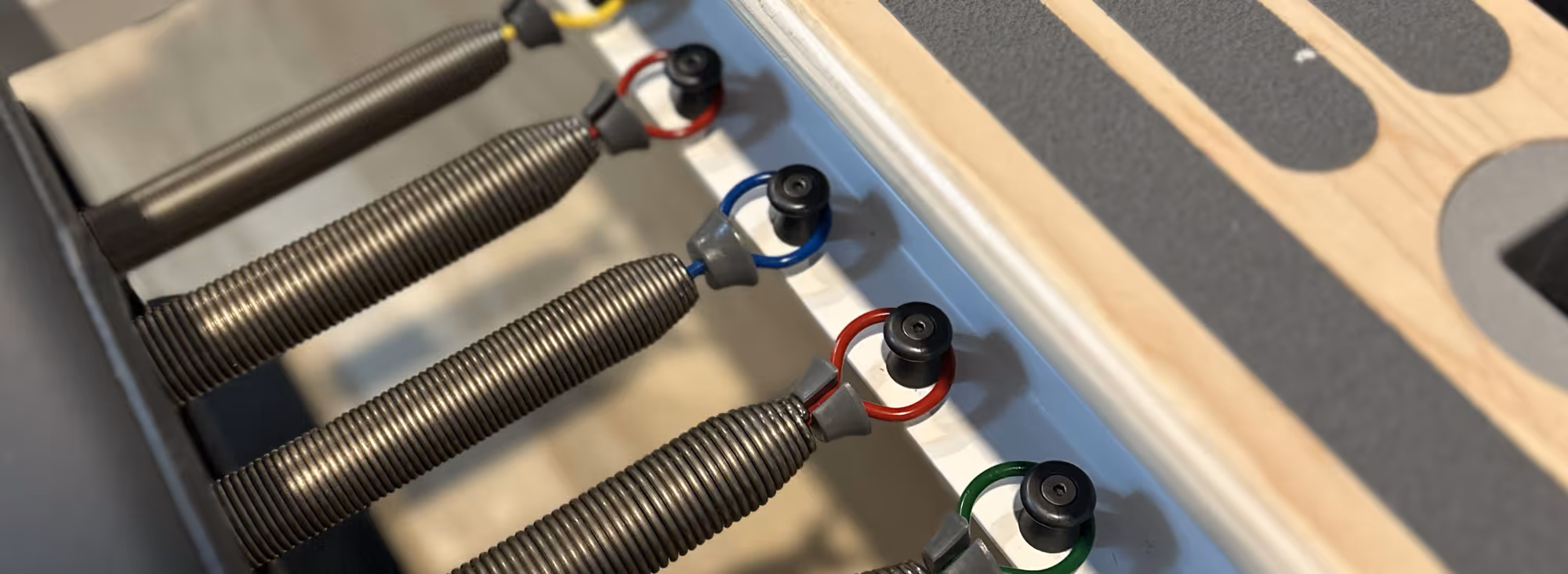 Pilates reformer spirngs in close up.