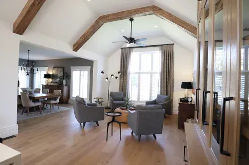 Living room with grey chairs and wooden ceiling boards