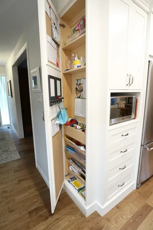 Open pantry door showing storage options inside