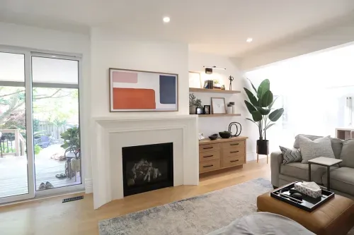 White brick fireplace with colourful painting hung above it