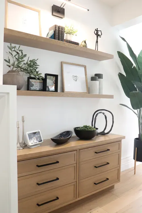 Decorative objects on floating shelves in great room