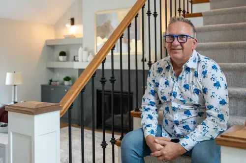 Homeowner sitting on staircase