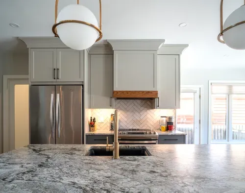 Kitchen wall featuring fridge, backsplash, and stove