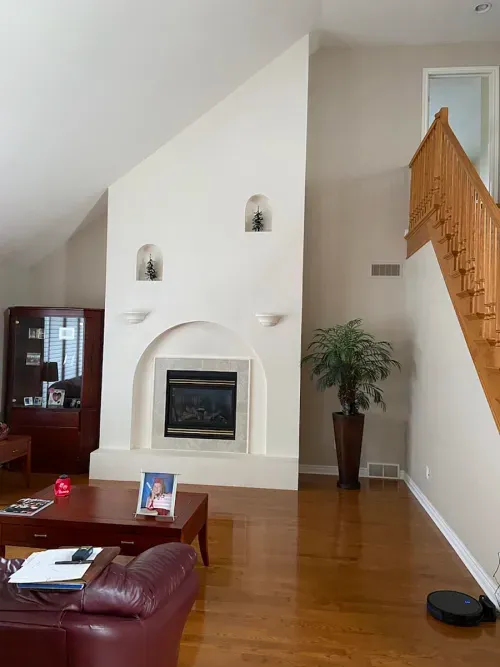 Before shot of smaller built in fireplace and great room