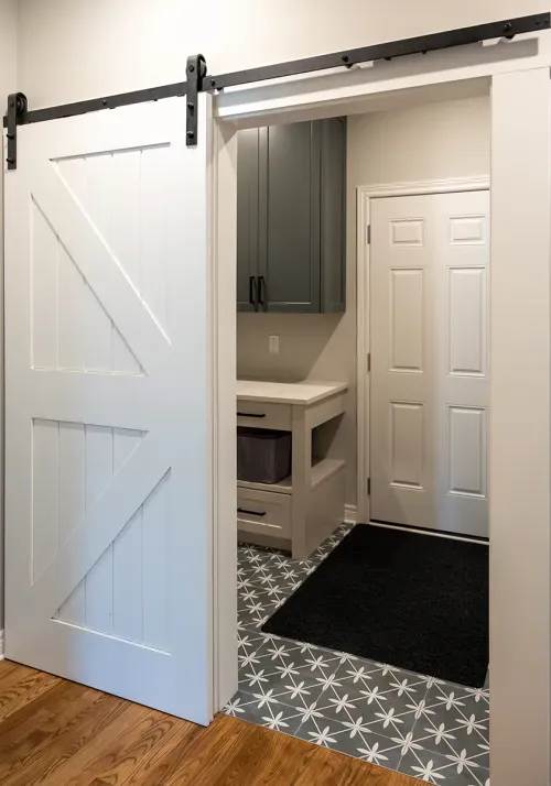 Sliding barn door leading to laundry room