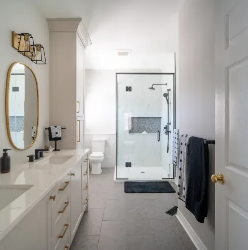 Ensuite bathroom with glass shower and black accents