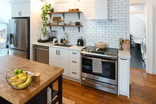 Kitchen wall with stove, fridge, dishwasher