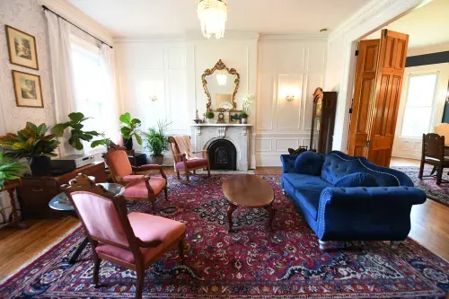 Living room with velvet sofa and chairs, fireplace