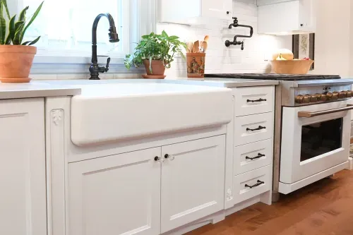 Deep kitchen sink with black faucet