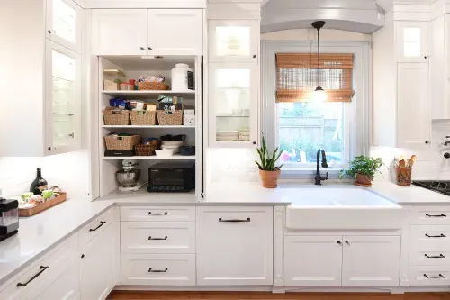 White kitchen cabinets doors opened to reveal pantry items