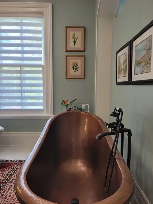 Claw foot tub with copper accents
