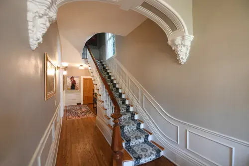 Foyer with wooden staircase and detailed accents