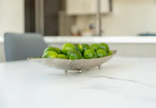 Close up of limes in bowl on kitchen table