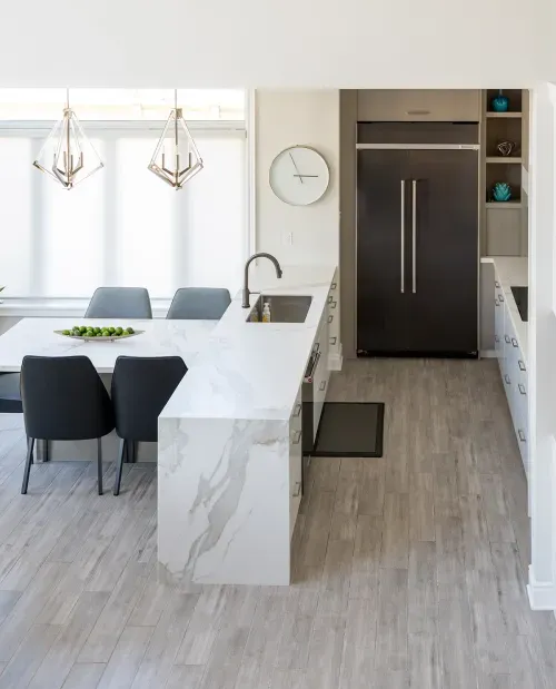 Large marble kitchen island and adjoining table
