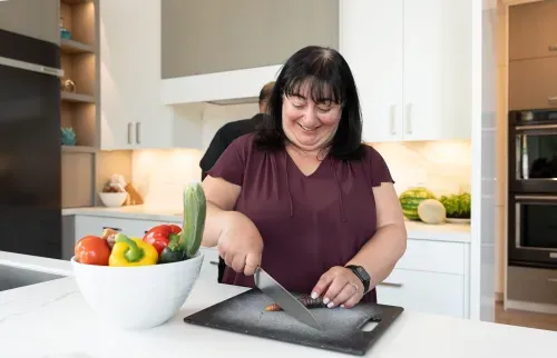 Homeowner preparing vegetables on cutting board