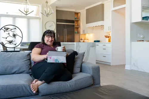 Homeowner sitting on living room couch