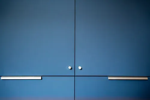 Close up details of navy kitchen cabinetry with clean lines and minimal door pulls