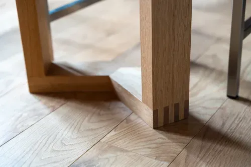Close up of craftmanship details on custom wooden dining table legs