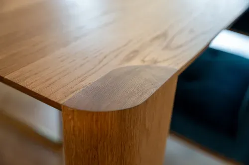 Close up of rounded edge of wooden dining table