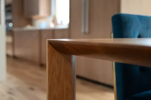 Close up detailing clean lines on custom wooden dining table