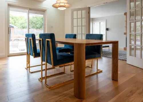 Custom built modern wooden dining table with blue velvet chairs
