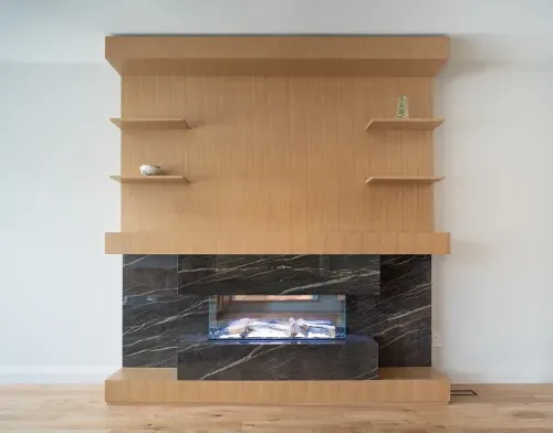 Front view of modern electric fireplace with marble face and wooden accents