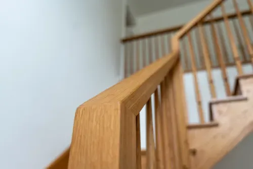 Detailed close up of wooden staircase railing from side