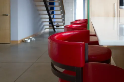 Red vynl kitchen stools in foreground, staircase in background